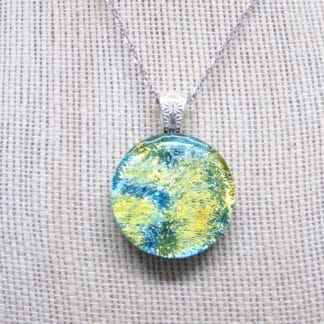 Greens with Blue Streams Dichroic Round Pendant. Handcrafted by DarteGlass, a woman owned brand.
