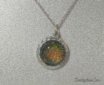 Gold and Green Glass Pendant in Decorative Setting