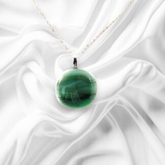 A glass pendant comprised of a variety of Green with some white accents and a stainless steel chain.