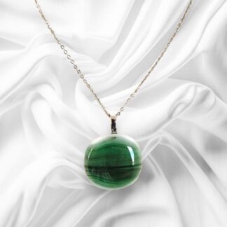 A glass pendant comprised of a variety of Green with some white accents and a stainless steel chain.