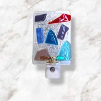 LED Autosensing Night Light with Multicolored Glass on Clear glass.