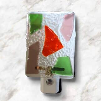 LED Autosensing Night Light with Multicolored Glass on Clear glass.