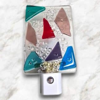 LED Autosensing Night Light with Multicolored Glass on Clear glass.