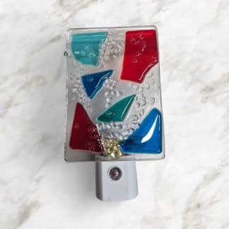 LED Autosensing Night Light with Multicolored Glass on Clear glass.